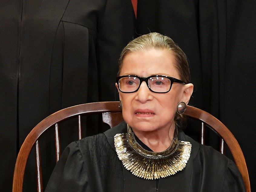 caption: Associate Justice Ruth Bader Ginsburg poses for the official photo at the Supreme Court in Washington, DC on November 30, 2018.