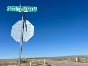caption: The road to the city-run gun range in Albuquerque, N.M. Police think the local culture around guns has changed, and one undercover cop estimates half the cars on the road now carry a firearm.