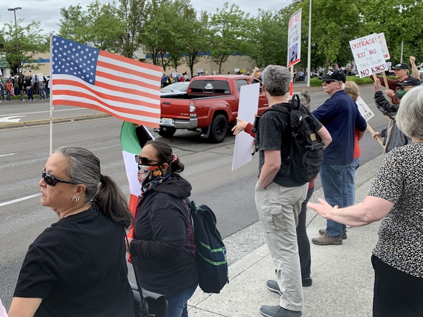 caption: Several thousand people gathered at Gretchen Fraser Neighborhood Park and marched down Mill Plain Boulevard in Vancouver, Wash., during a “No Kings” protest on June 14, 2025.
