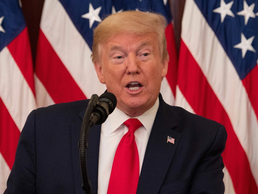 caption: President Trump speaks at the White House Friday. He is replacing an official who issued a report that found testing delays and equipment shortages at hospitals.