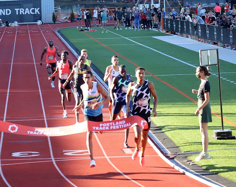 caption:  Donavan Brazier breaks the tape in an 800 meter tune-up race in Portland on May 29, ahead of the U.S. Olympic Track and Field Team Trials, which begin later this week.