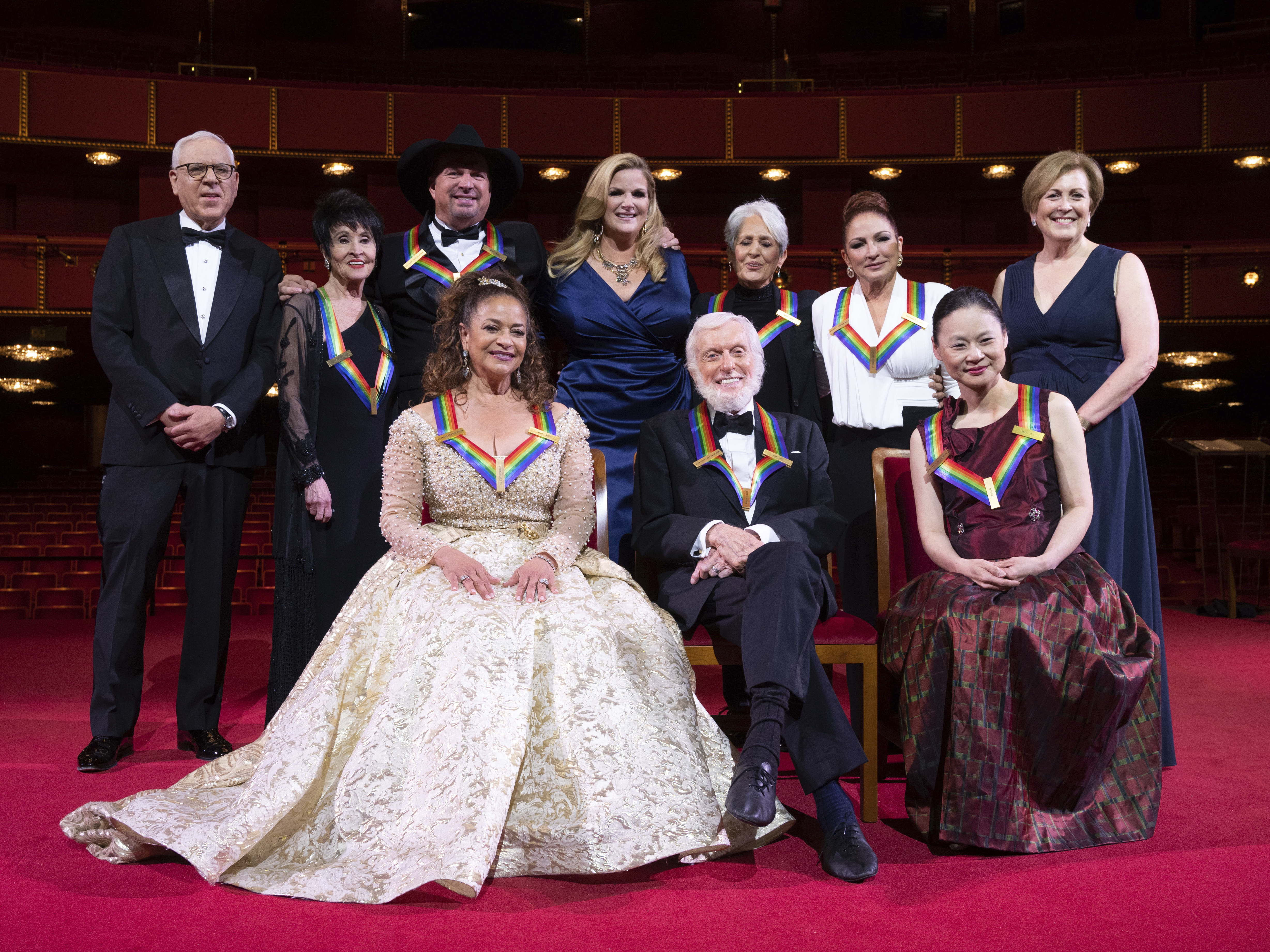 caption: David Rubenstein, Chita Rivera, Garth Brooks, Debbie Allen, Trisha Yearwood, Dick Van Dyke, Joan Baez, Gloria Estefan, Midori, and Kennedy Center president Deborah F. Rutter pose for a group photo at the 43nd annual Kennedy Center Honors.