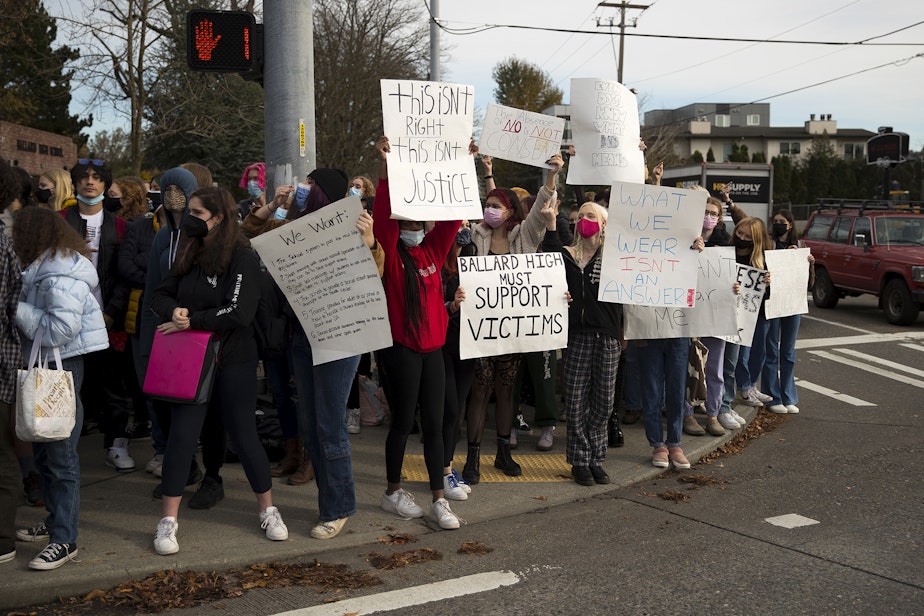 caption: Ballard High School students protest during lunch period at the intersection of Northwest 65th Street and 15th Avenue Northwest, while standing in solidarity with victims of sexual assault and presenting a list of demands for the school, on Monday, November 8, 2021, in Seattle.