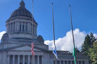 caption: The Israeli flag flies at half staff next to the U.S. flag and Washington state flag at the state Capitol in Olympia, Oct. 12, 2023. Gov. Jay Inslee ordered the flag to be raised in the week after Hamas attacked Israel. 