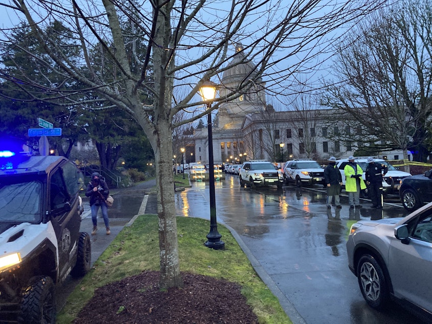 caption: A State Patrol checkpoint greeted arriving state lawmakers at the Washington Capitol on the first day of the legislative session in January. The unprecedented security followed the January 6 attack on the U.S. Capitol.