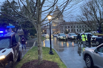 caption: A State Patrol checkpoint greeted arriving state lawmakers at the Washington Capitol on the first day of the legislative session in January. The unprecedented security followed the January 6 attack on the U.S. Capitol.