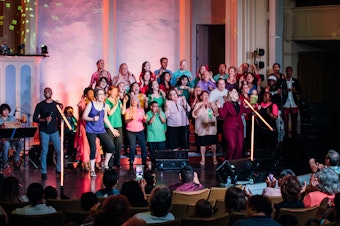 caption: The Tacoma Refugee Choir performs.
