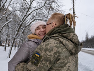 caption: Yulya Dmytrieeva and her husband, Vadym, who have been together for over a decade, embrace in the snow in Sloviansk. They will spend a few days together while he has a break from the trenches on the front lines.