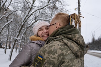 caption: Yulya Dmytrieeva and her husband, Vadym, who have been together for over a decade, embrace in the snow in Sloviansk. They will spend a few days together while he has a break from the trenches on the front lines.