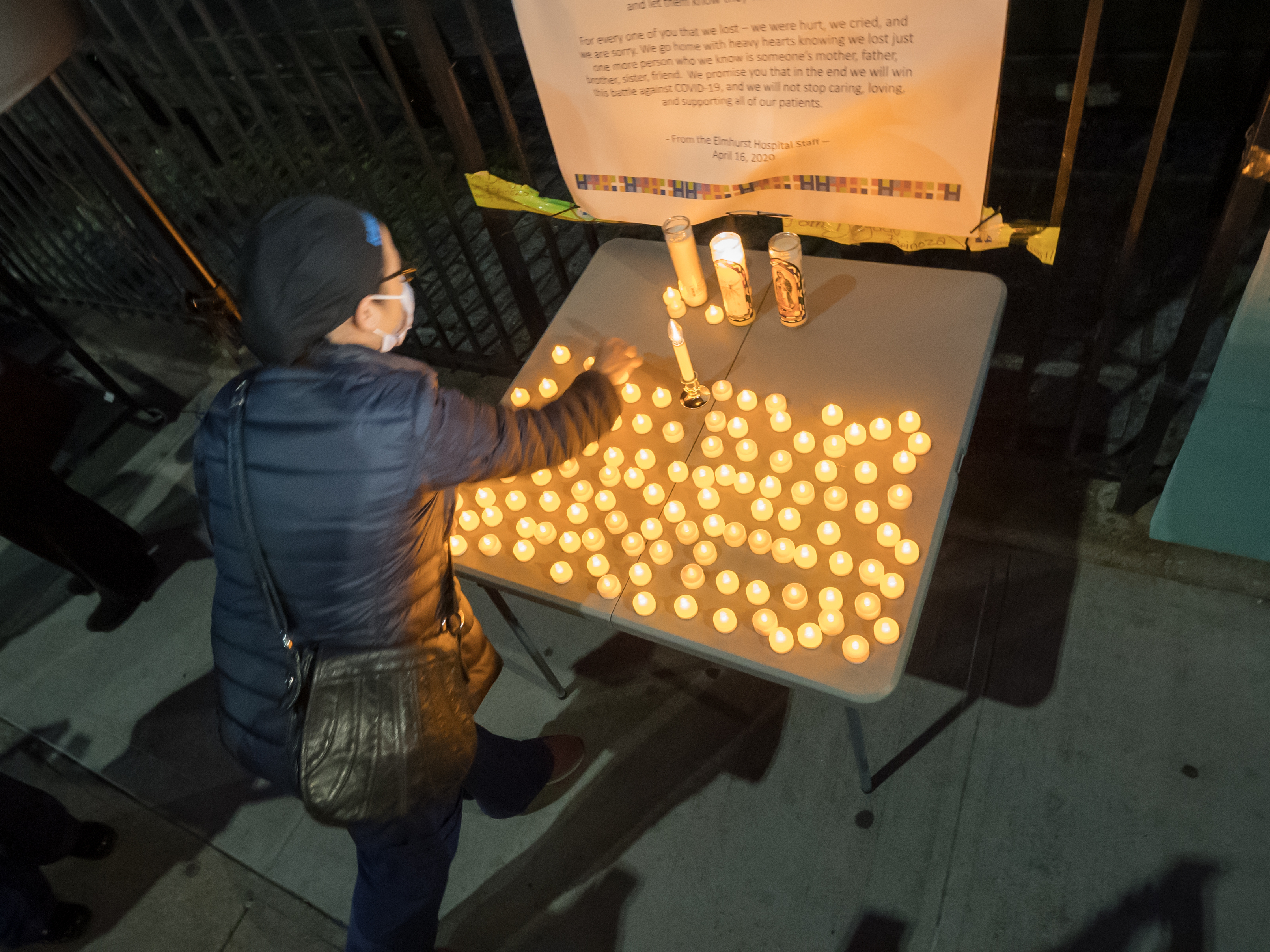 caption: The U.S. death toll from COVID-19 hit a new milestone, surpassing the number of Americans who died in the prolonged conflict with Vietnam. Here, the Elmhurst Hospital Center in Queens, N.Y., holds a vigil for medical workers and patients who have died in the pandemic.