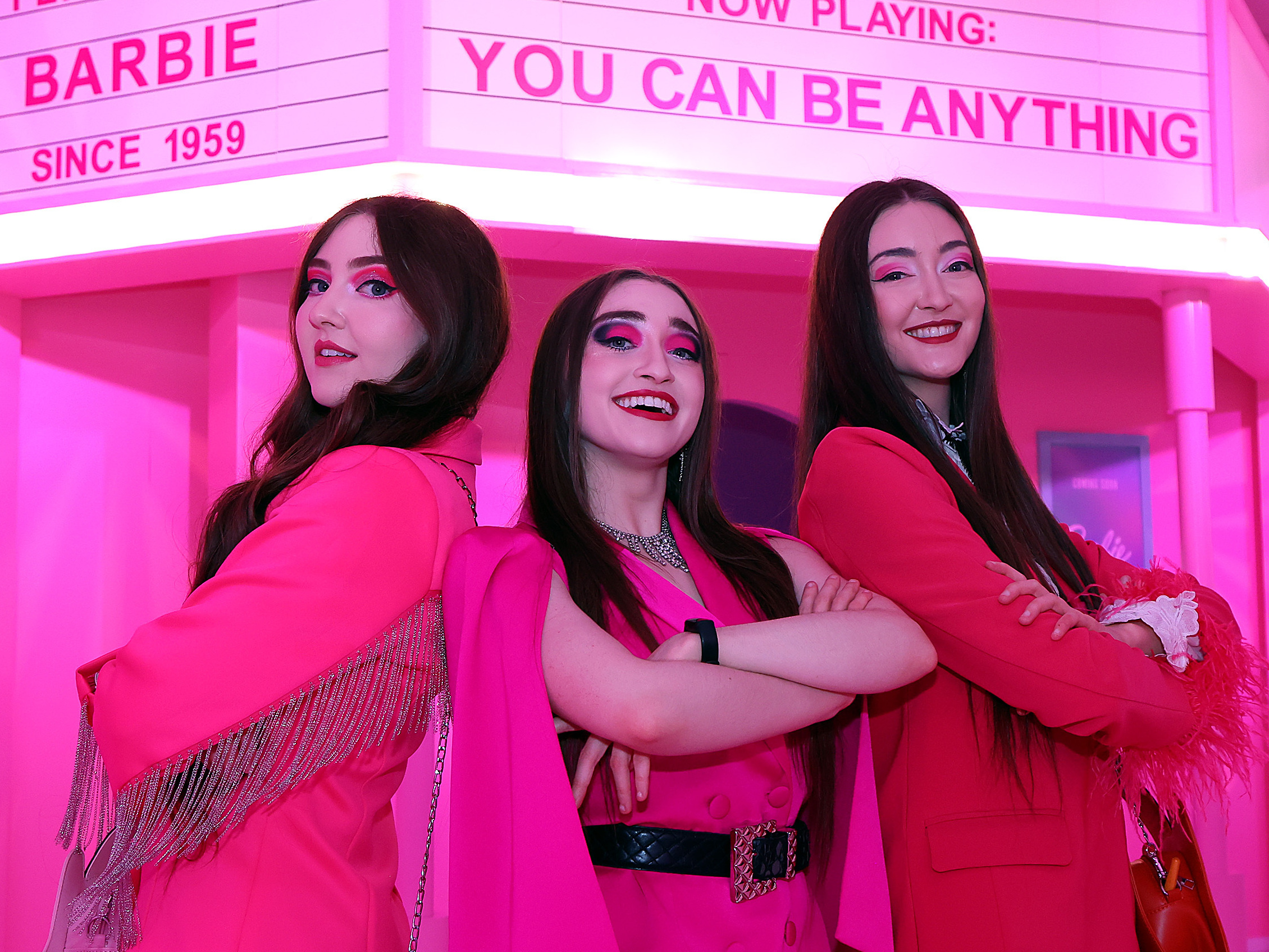 caption: Kelsey, Kristen and Kaylen Kassab of The K3 Sisters Band in front of the Barbie Theater at World of Barbie at Stonebriar Centre Mall on in Frisco, Texas.