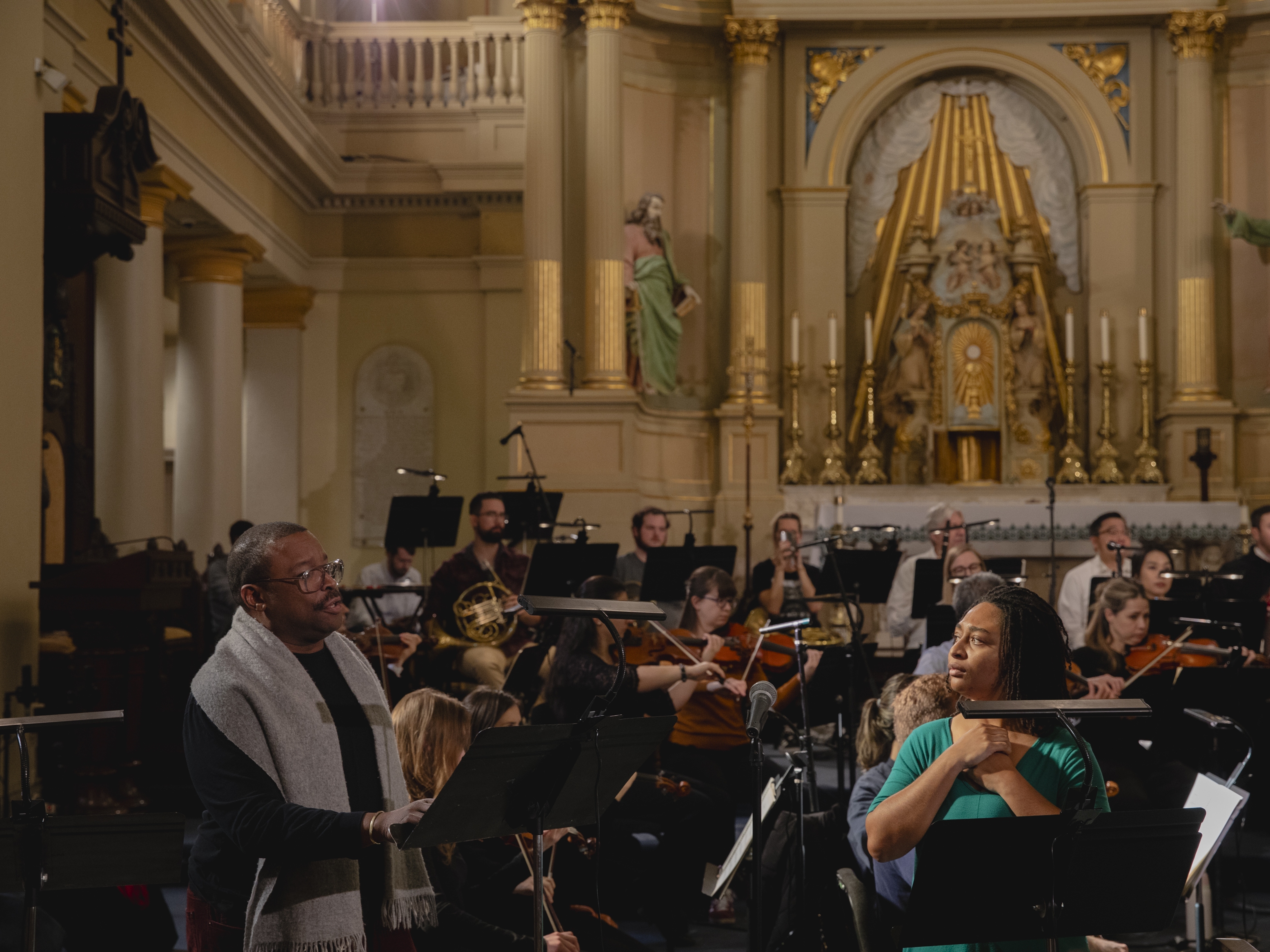 caption: Tenor Chauncey Packer, left, and soprano Taylor J. White, white, rehearse Edmond Dédé's opera <em>Morgiane</em> at St. Louis Cathedral in New Orleans on Jan. 24, 2025, along with members of Opera Lafayette, OperaCréole and the Louisiana Philharmonic Orchestra.