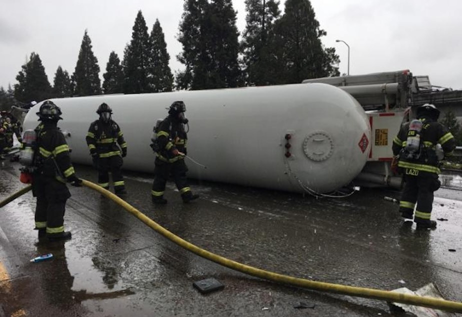 caption: This tanker truck rolled over last month when it braked to avoid hitting stopped cars ahead. I-5 through Seattle was closed for most of the day. But crews secured the propane tank, preventing an explosion.