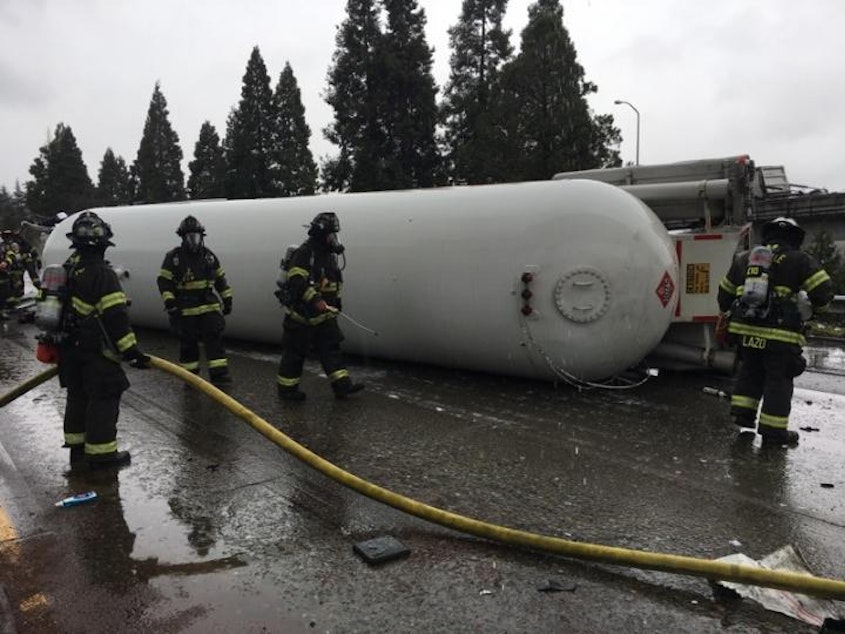 caption: This tanker truck rolled over last month when it braked to avoid hitting stopped cars ahead. I-5 through Seattle was closed for most of the day. But crews secured the propane tank, preventing an explosion.