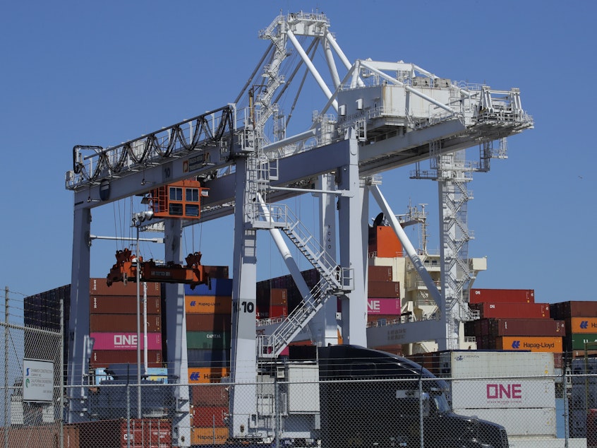 caption: A container ship is unloaded at the Port of Oakland in California. A drop in exports contributed to a slowdown in U.S. economic growth in the second quarter.