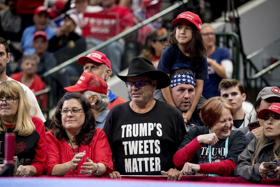 caption: A member of the audience wears a shirt that reads "Trump's Tweets Matter" before President Donald Trump takes the stage at a campaign rally at American Airlines Arena in Dallas, Texas, Thursday, Oct. 17, 2019. 