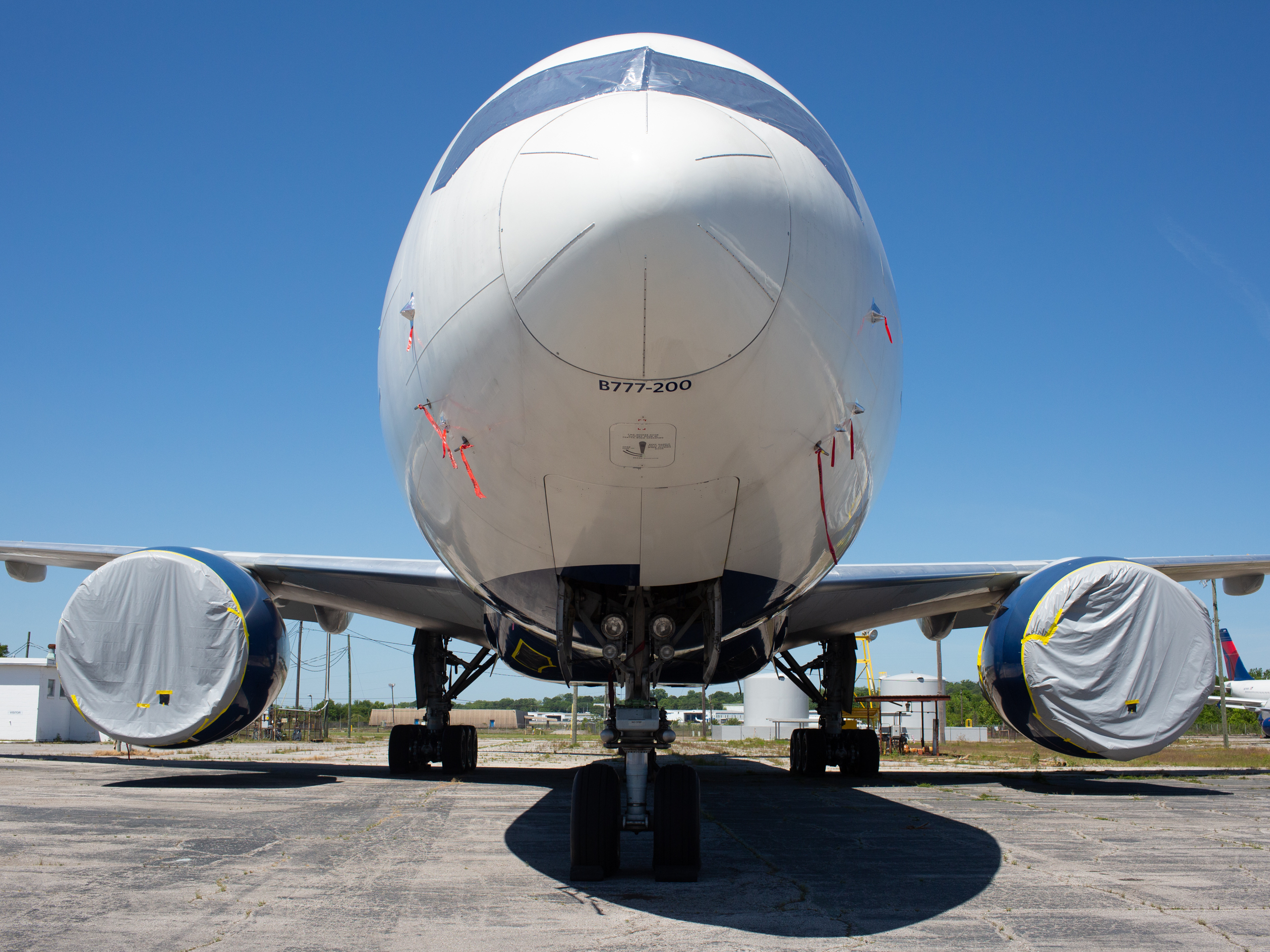 caption: A Delta Boeing 777 stays put in storage at the Birmingham-Shuttlesworth International Airport on May 1. It's one of dozens of Delta planes parked at the airport because of the coronavirus pandemic.