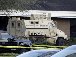 caption: A Highlands County Sheriff's SWAT vehicle is stationed in front of a SunTrust Bank branch, Wednesday in Sebring, Fla., where authorities say five people were killed in a shooting.