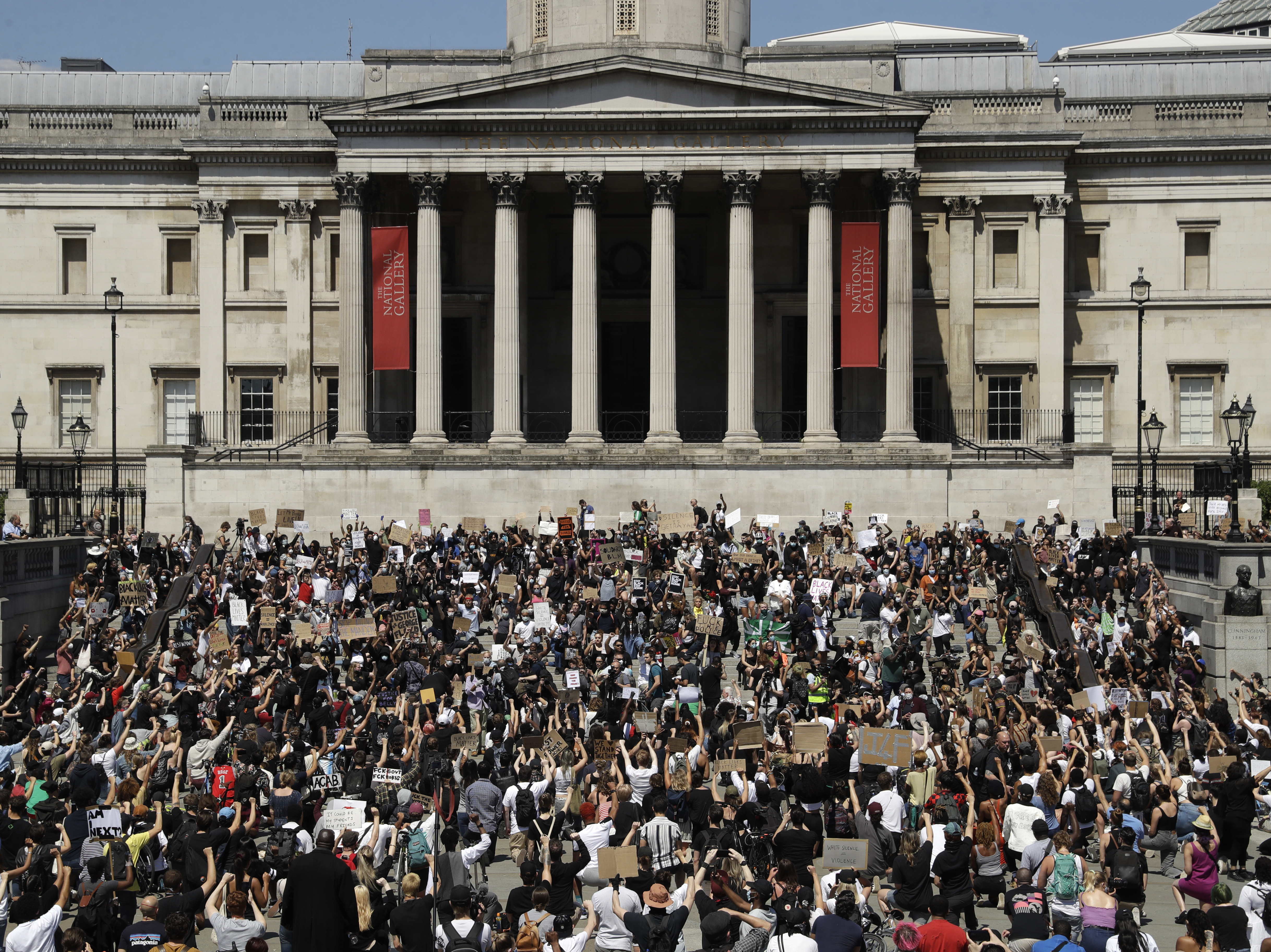 caption: Hundreds demonstrated in Trafalgar Square in central London on Sunday, and many kneeled, to protest the recent killing of George Floyd by police officers in Minneapolis.