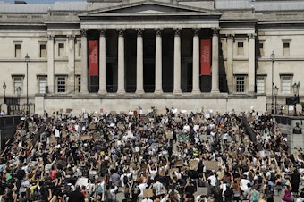 caption: Hundreds demonstrated in Trafalgar Square in central London on Sunday, and many kneeled, to protest the recent killing of George Floyd by police officers in Minneapolis.