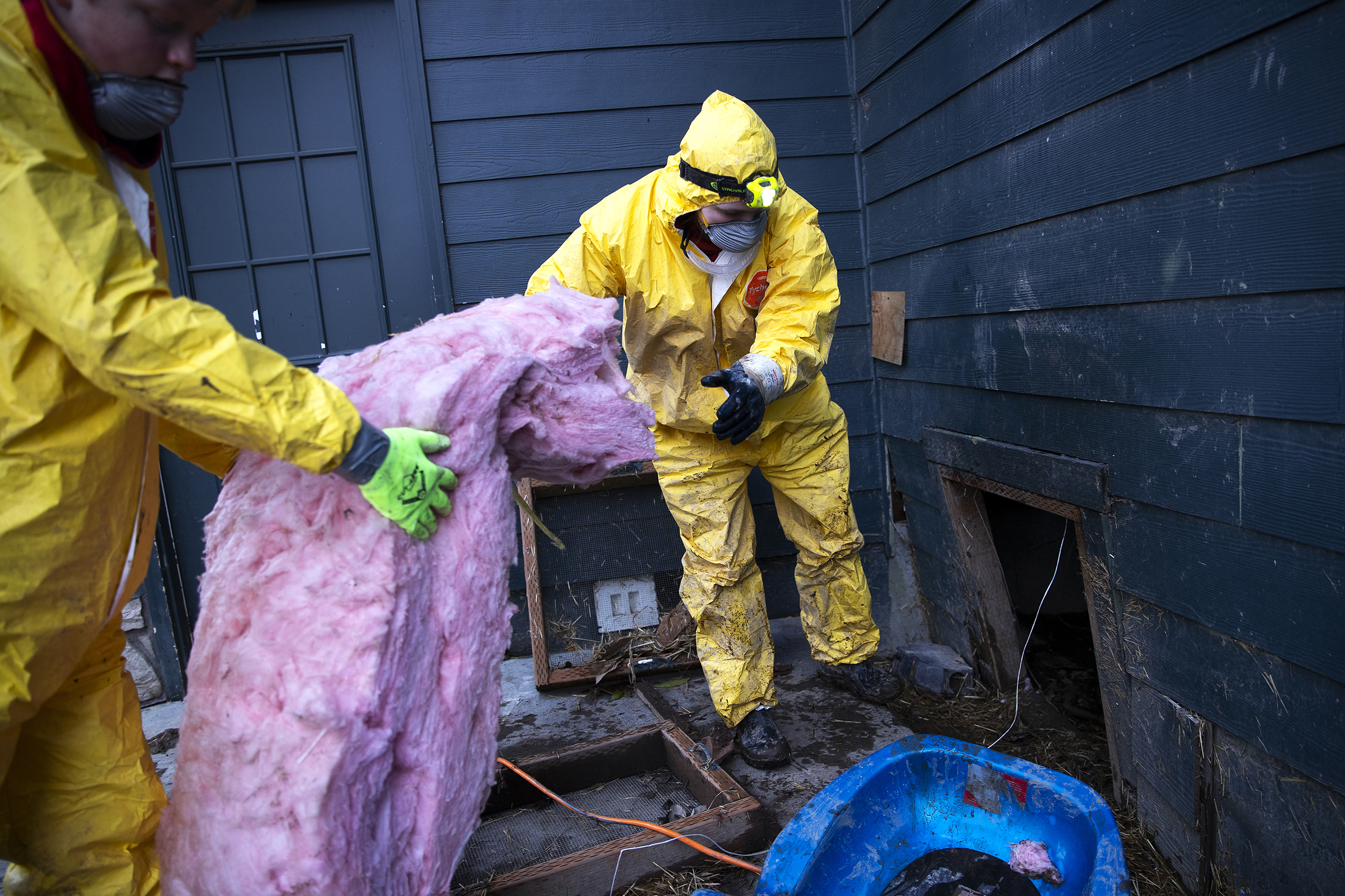 caption: Student volunteers from Nooksack Valley Highschool, Henry Nonhoff, 14, left, and Violet Hunt, 17, right, remove insulation from a flooded crawl space on Wednesday, December 17, 2025, in Sumas. Flooding is expected to surpass a record set in 1990, when floods caused two human fatalities, over 2,000 evacuations, and more than $100 million in damage, according to a Natural Disaster Survey report.