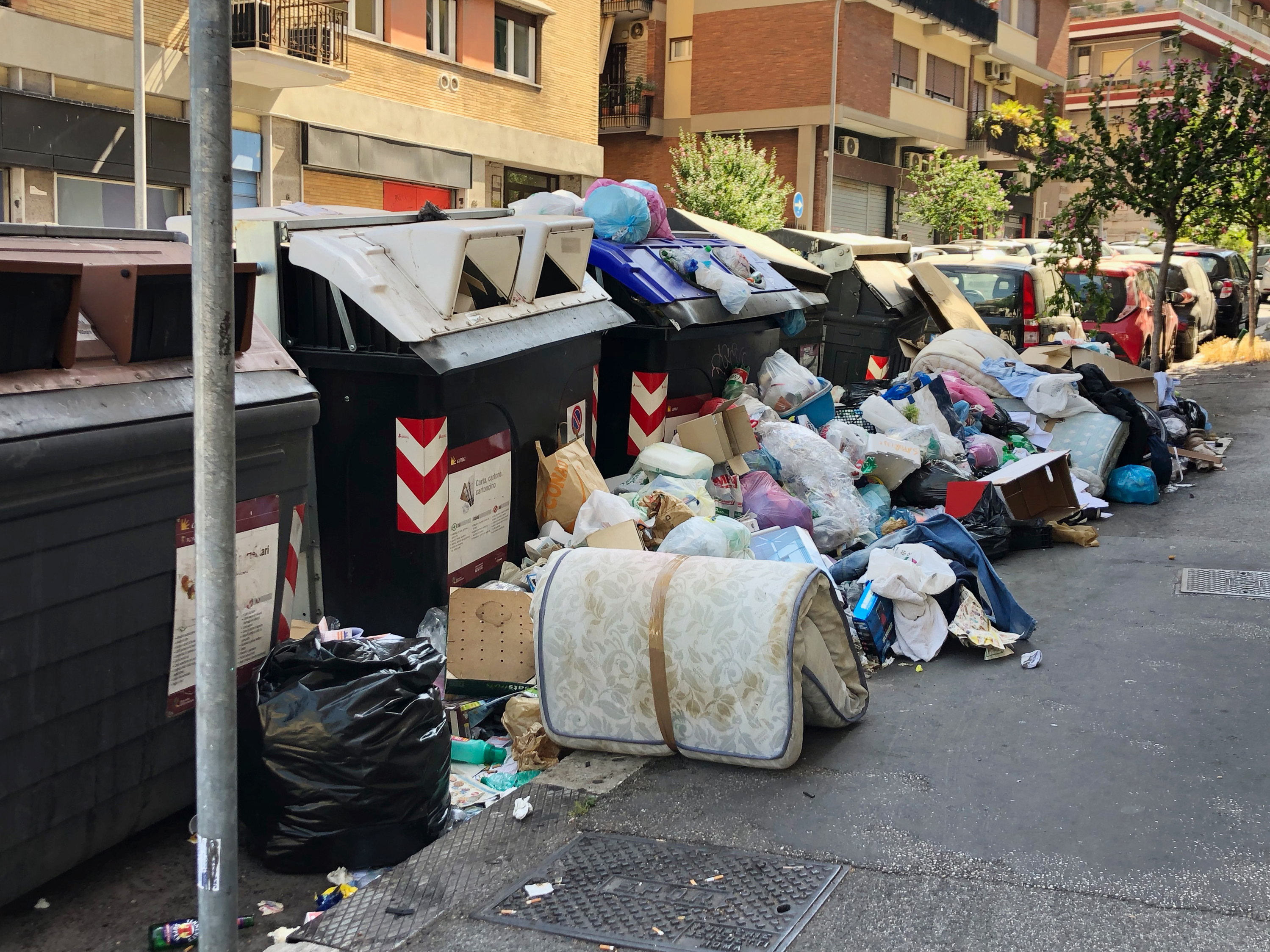 caption: Trash piles in Monteverde, a residential neighborhood in Rome. During this scorching hot summer, the city's residents and visitors are being tested by a massive trash crisis that has prompted doctors to warn of the possible spread of diseases as birds, vermin and wild animals scavenge amid the rotting refuse.