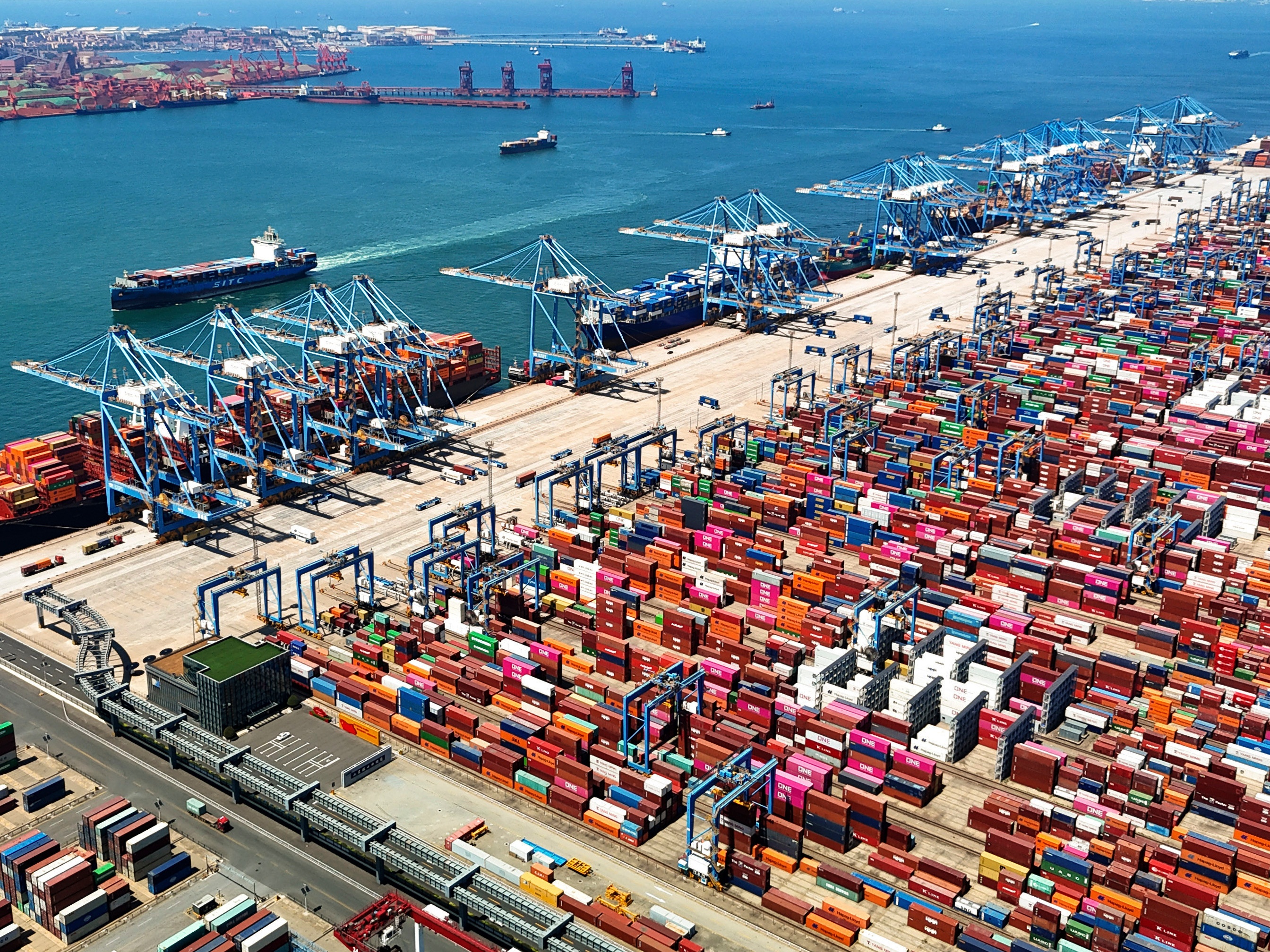 caption: An aerial view of a container port is seen in Qingdao in east China's Shandong province, on June 6, 2024.