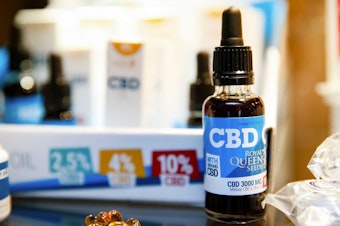 caption: Oils containing cannabidiol (CBD) are seen in a shop in Paris on June 14, 2018. (Geoffroy Van Der Hasselt/AFP/Getty Images)