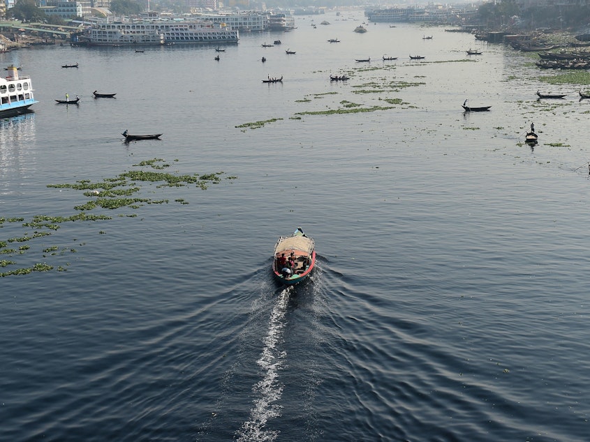 caption: Bangladeshi commuters use boats to cross the Buriganga River in the capital Dhaka in 2018. In July, Bangladesh's top court granted all the country's rivers the same legal rights as humans.