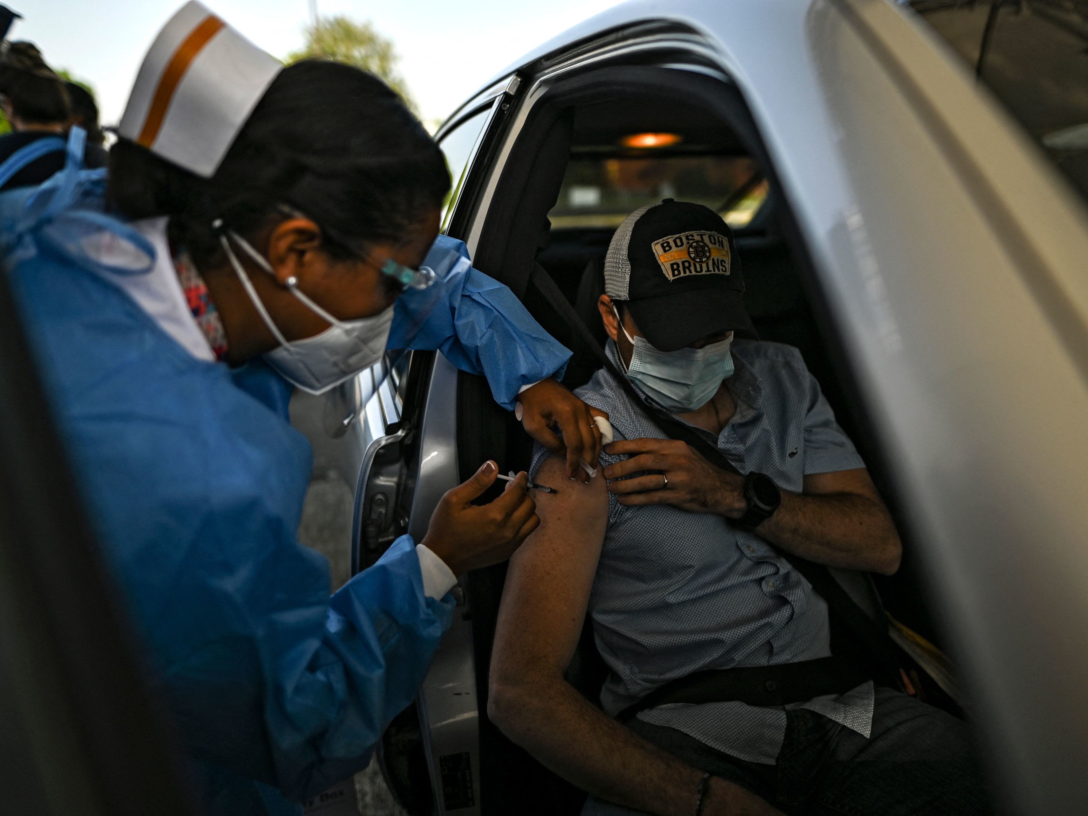 caption: A man receives a dose of the AstraZeneca COVID-19 vaccine at the Rommel Fernández Stadium in Panama City, Panama. In the absence of Food and Drug Administration authorization, the U.S. government has been sitting on a stockpile of doses.
