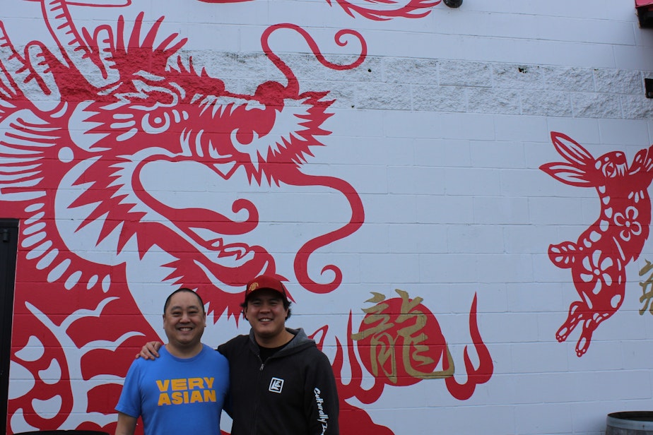 caption: Raymond Kwan, left, and Barry Chan pose in front of the mural of Chinese Zodiac animals outside Lucky Envelope Brewery in Seattle's Ballard neighborhood. Every Chinese Lunar New Year, their brewery crafts beer for the occasion (dragon, rooster, rabbit, etc.). It's one way they include their Chinese heritage in their work. 
