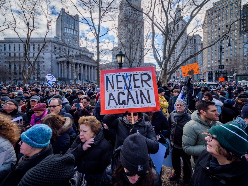 caption: A participant holding a sign at a 2020 solidarity march in unity against the rise of antisemitism. The Anti-Defamation League reported that antisemitic incidents reached an all-time high in 2021.