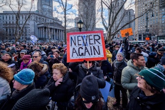 caption: A participant holding a sign at a 2020 solidarity march in unity against the rise of antisemitism. The Anti-Defamation League reported that antisemitic incidents reached an all-time high in 2021.