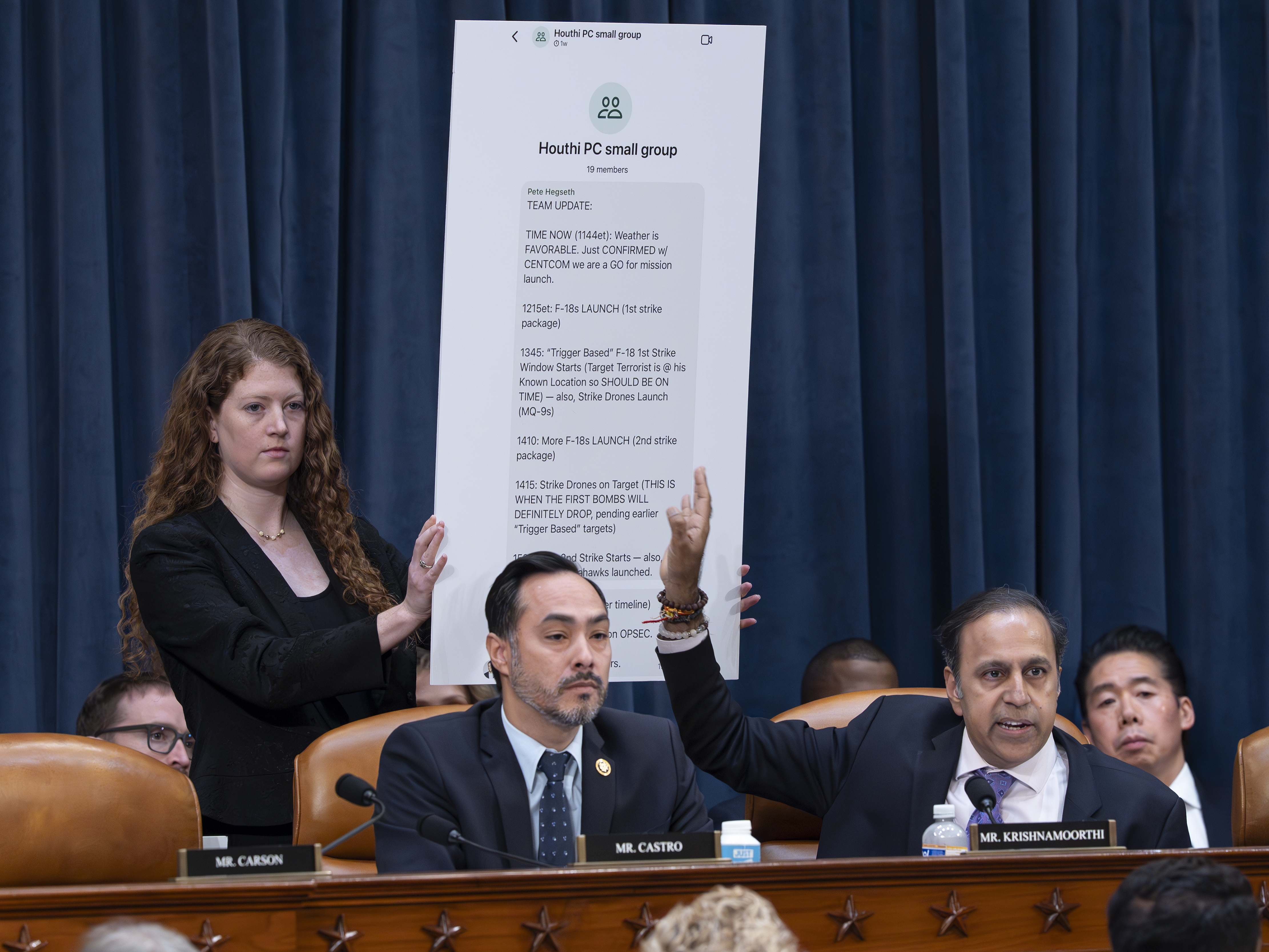 caption: Rep. Raja Krishnamoorthi, D-Ill., (right), joined by Rep. Joaquin Castro, D-Texas, points to a chart displaying a text message by Defense Secretary Pete Hegseth in a group chat that revealed U.S. military plans in Yemen to a journalist, at a House Intelligence Committee hearing Wednesday in Washington.
