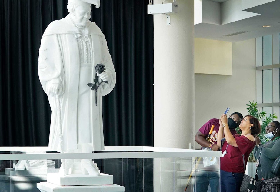 caption: Members of the public view the newly unveiled statue of Mary McLeod Bethune at the News-Journal Center in Daytona Beach on Oct. 12, 2021. It's slated to move to the U.S. Capitol Building's National Statuary Hall early next year.