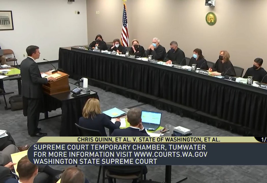 caption: Solicitor General Noah Purcell argues in support of the capital gains tax before WA Supreme Court on Jan. 26, 2023.