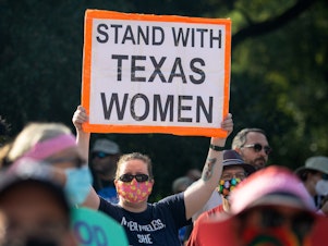 caption: A number of companies with staff in Texas has offered to pay for abortion-related travel.