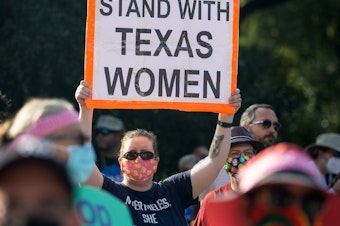 caption: A number of companies with staff in Texas has offered to pay for abortion-related travel.