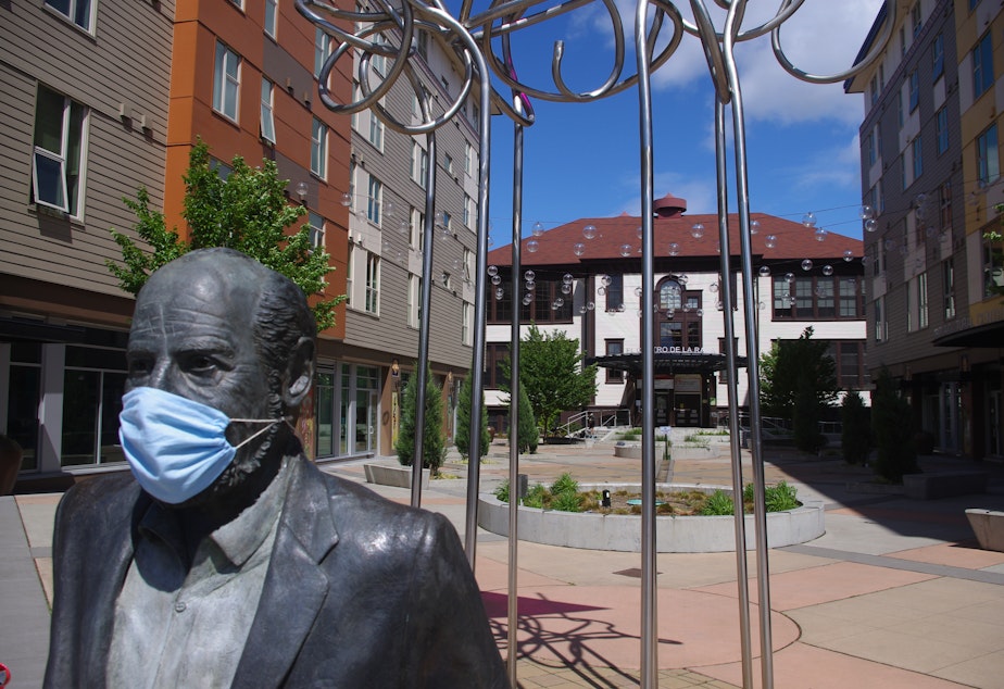 caption: The statue of Roberto Maestas, founder of El Centro de la Raza in Seattle, is adorned with a mask during the coronavirus pandemic. 