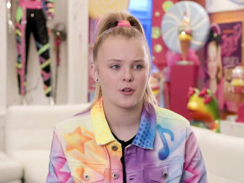 caption: In this screengrab, JoJo Siwa speaks during Instagram and Facebook's Creator Week on June 8, in Los Angeles. Siwa will be dancing with a female pro on this season's <em>Dancing with the Stars</em>.