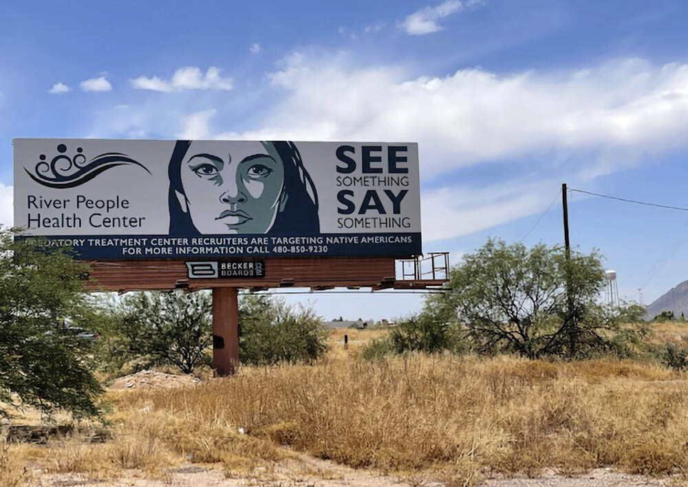 caption: A billboard is seen in Scottsdale, Ariz., Saturday, June 10, 2023, near the health care facility of the Salt River Pima-Maricopa Indian Community, which has been affected by a gigantic Medicaid fraud scheme involving sober living homes that promised help to Native Americans seeking to kick alcohol and other additions. (Anita Snow/AP)