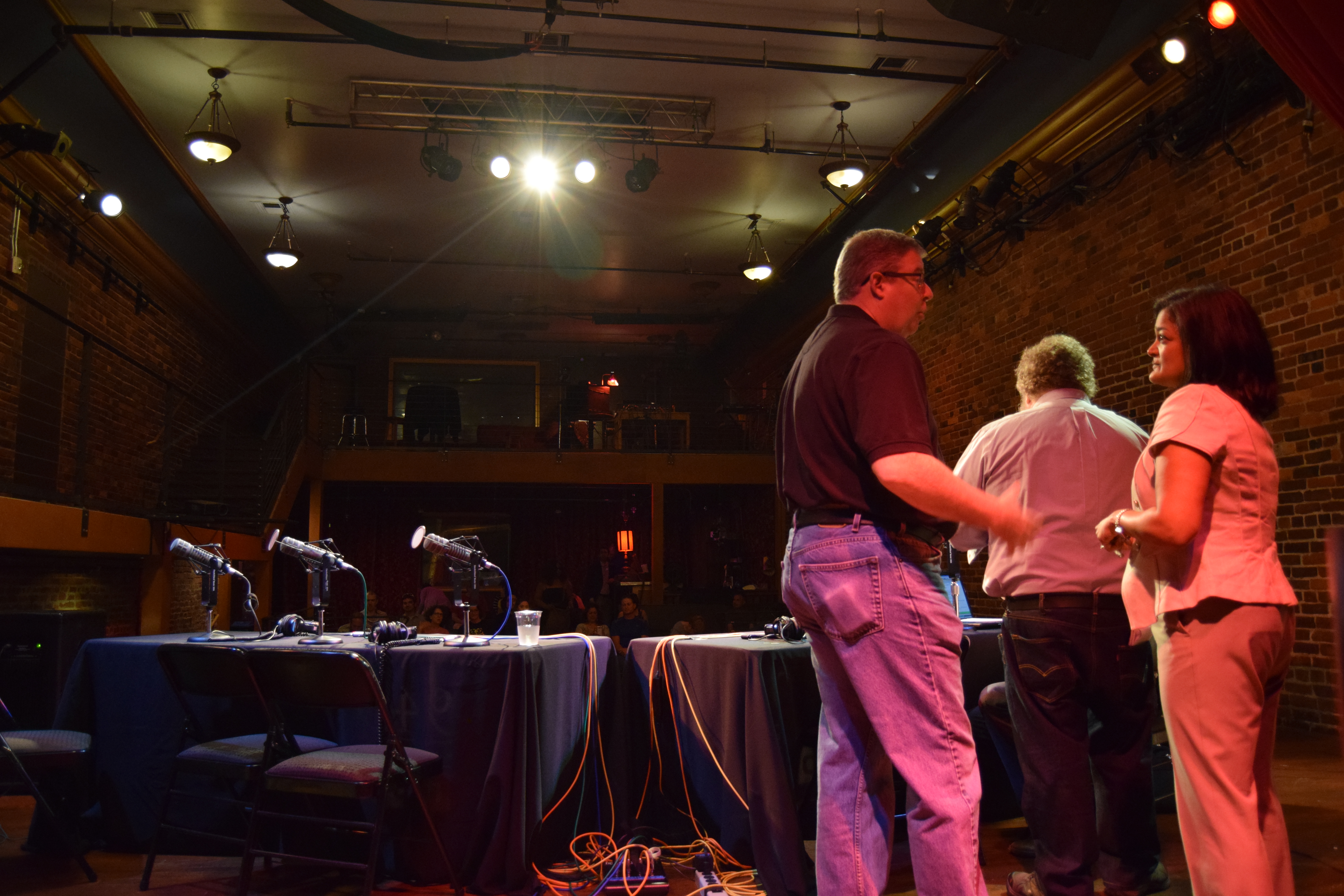 caption: Pramila Jayapal talks with former Washington GOP head Chris Vance at a taping of KUOW's 'Week in Review' at Columbia City Theatre on June 5, 2015.
