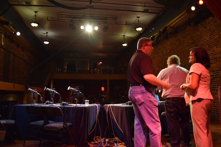caption: Pramila Jayapal talks with former Washington GOP head Chris Vance at a taping of KUOW's 'Week in Review' at Columbia City Theatre on June 5, 2015.