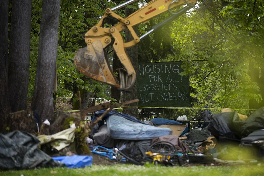 caption: The city of Seattle removed unhoused people and their belongings from an encampment on Tuesday, May 10, 2022, at Woodland Park in Seattle. 