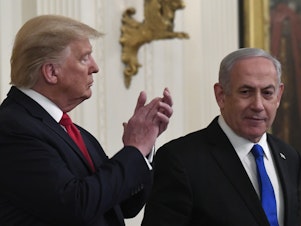 caption: President Donald Trump applauds as Israeli Prime Minister Benjamin Netanyahu speaks during Tuesday's announcement of the Trump administration's plan to resolve the Israeli-Palestinian conflict.
