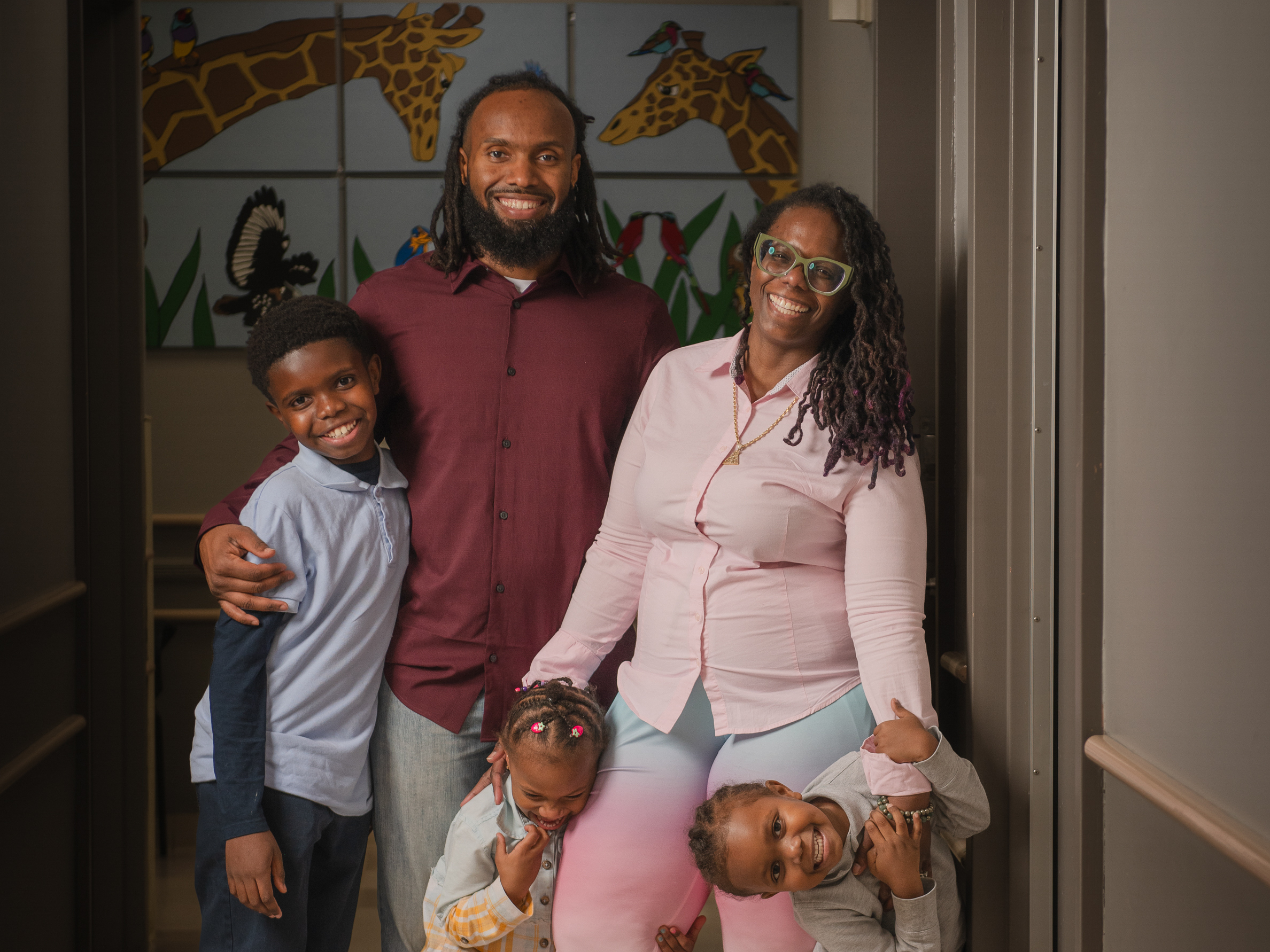 caption: Teresa Cox-Bates and her husband John Bates, along with their kids Eli, Ava and Issac. Teresa says HealthySteps has helped her face her own childhood trauma and be a better parent.