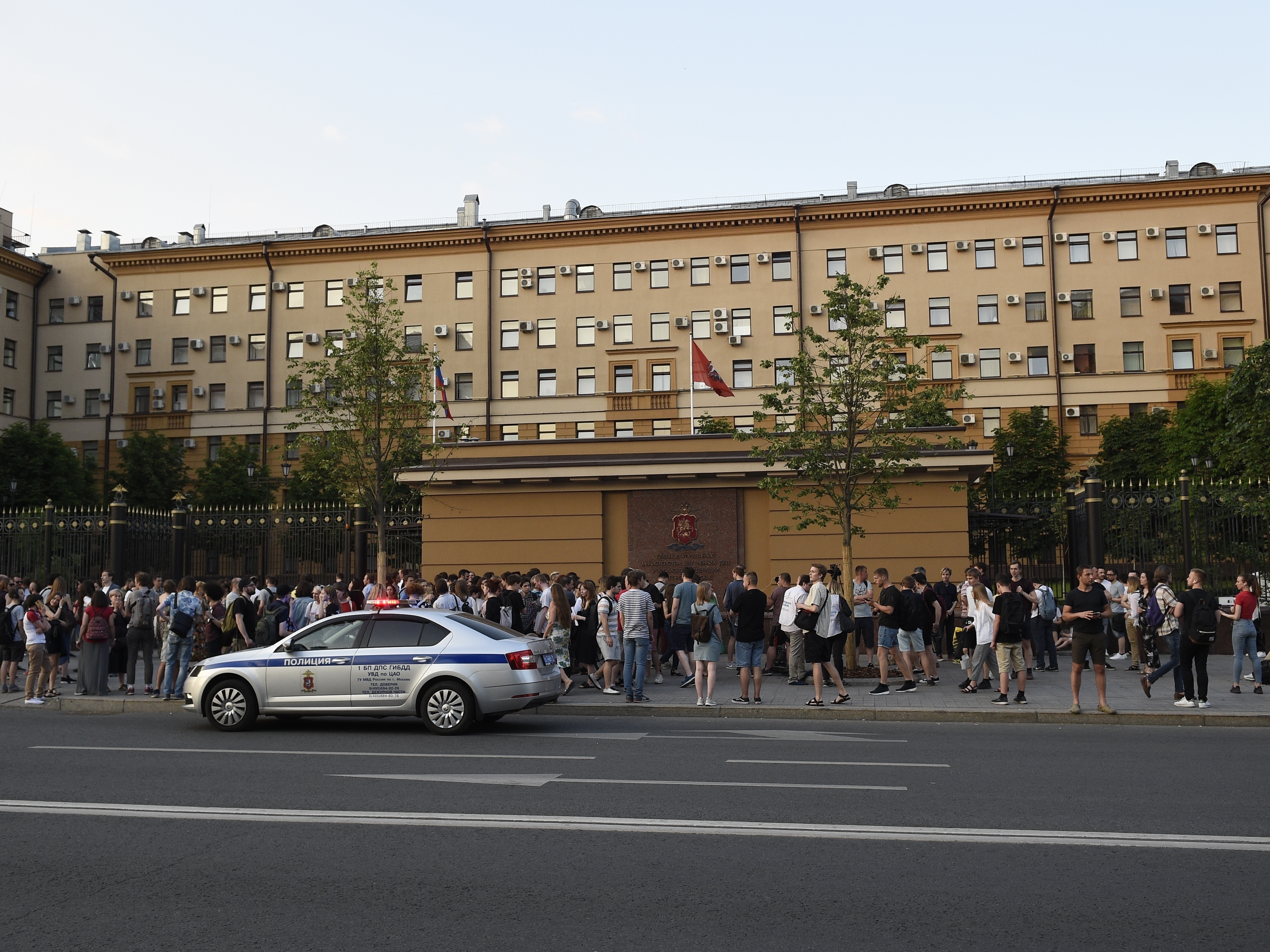 caption: Supporters of detained journalist Ivan Golunov rally at the Moscow police headquarters on Friday, June 7.