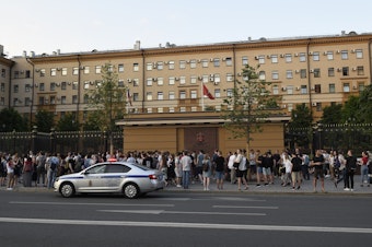 caption: Supporters of detained journalist Ivan Golunov rally at the Moscow police headquarters on Friday, June 7.