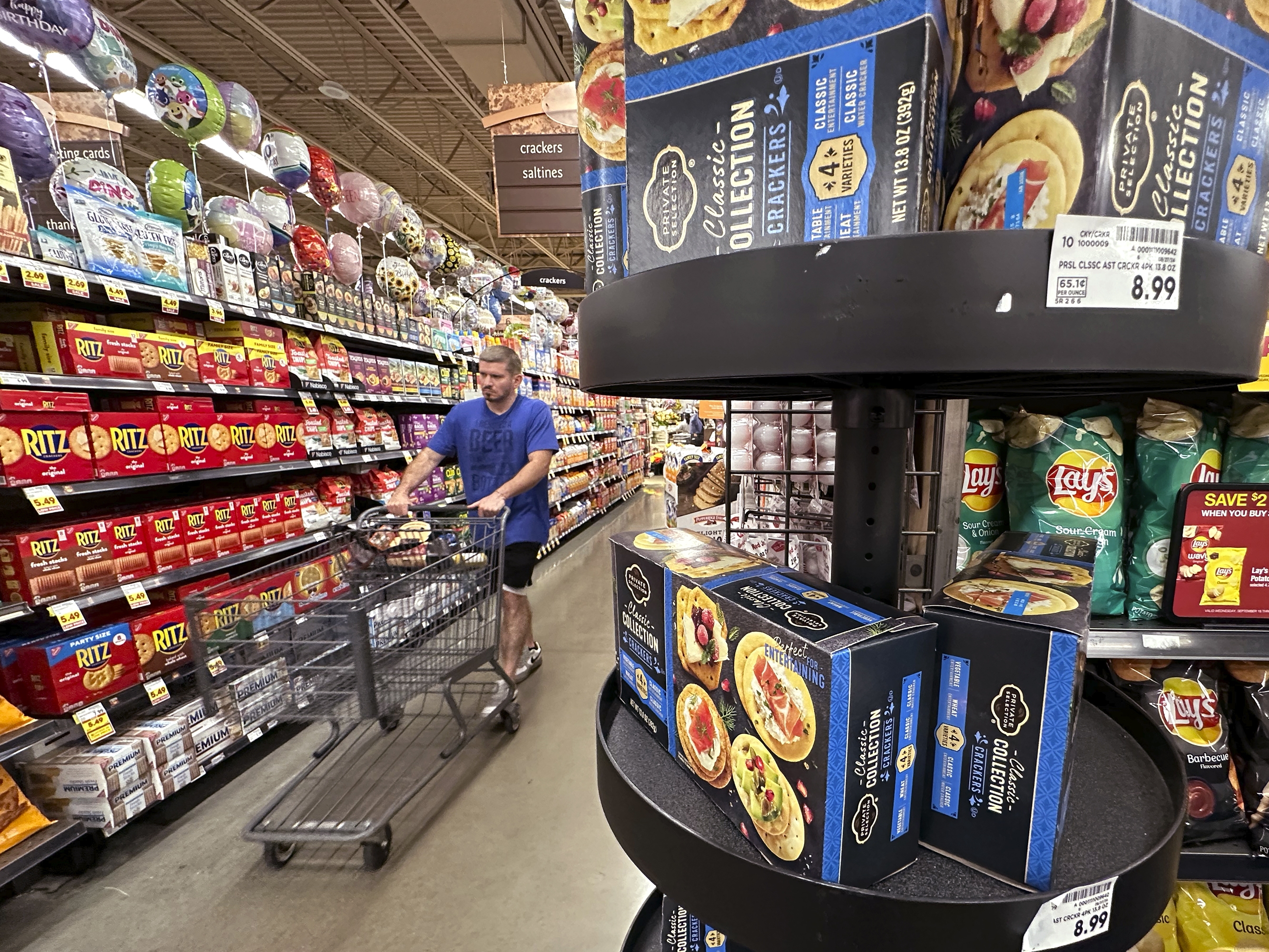 caption: A customer shops for groceries at a Chicago supermarket.