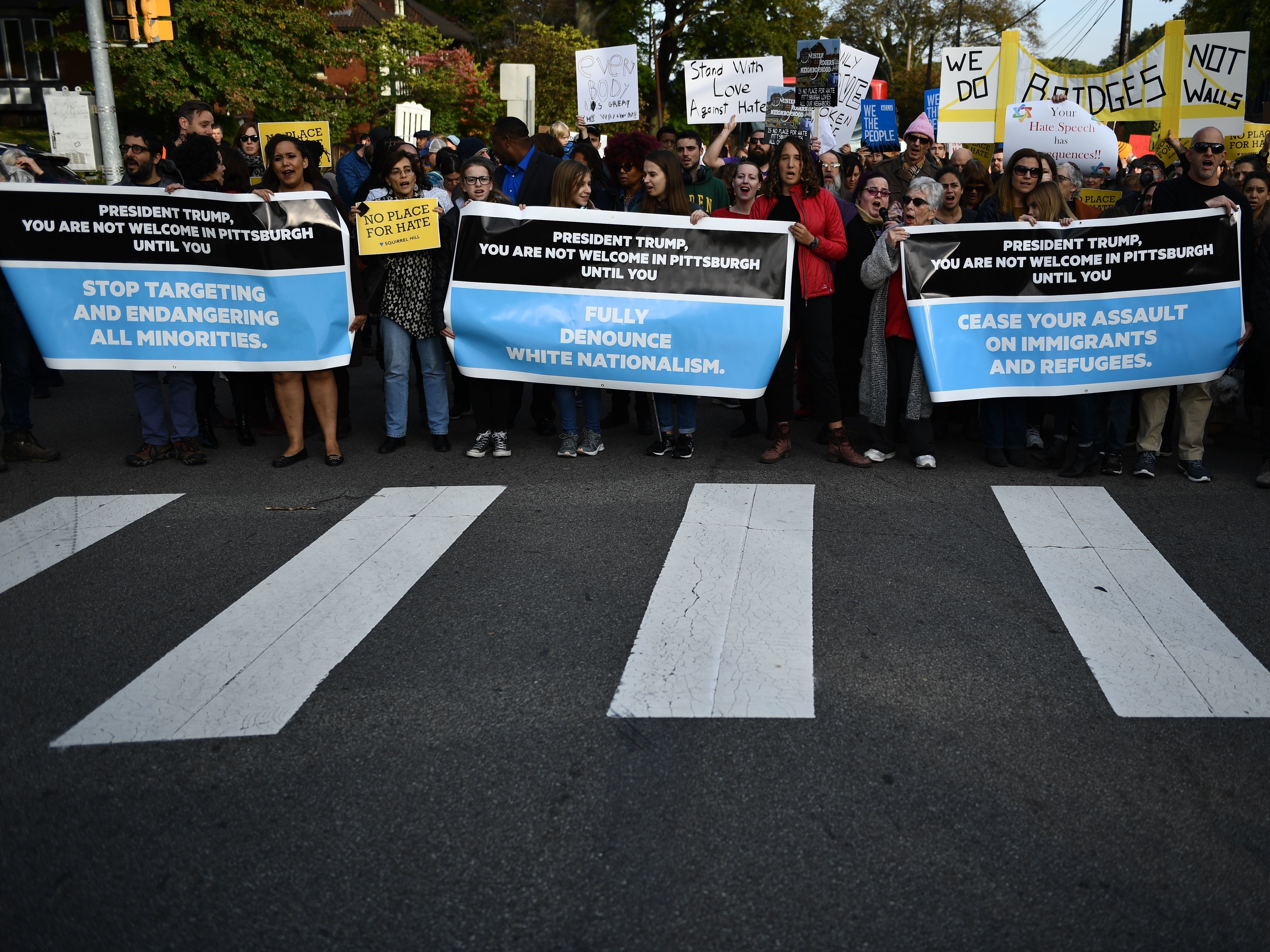 caption: People protesting against President Trump gather near the Tree of Life Congregation on Wednesday in Pittsburgh, Pa.